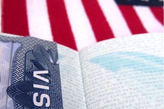 passport book with visa paper open on red and white